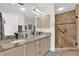 Elegant bathroom featuring double sinks, granite countertops, and a glass-enclosed shower at 1273 Oak Forest Dr, The Villages, FL 32162