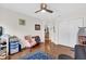 Bedroom featuring a ceiling fan, closet, hardwood floors, and natural light at 1273 Oak Forest Dr, The Villages, FL 32162