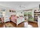 Cozy bedroom with hardwood floors, ceiling fan, natural light, and a comfortable queen bed at 1273 Oak Forest Dr, The Villages, FL 32162