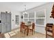 Cozy breakfast nook featuring tile floors, large windows and comfortable seating for four at 1273 Oak Forest Dr, The Villages, FL 32162