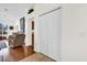 Hallway leading to living room, featuring wood floors, ample closet space and neutral color palette at 1273 Oak Forest Dr, The Villages, FL 32162