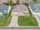 Aerial view featuring a home with a green lawn, set in a peaceful neighborhood at 1303 Fontana Ct, Lady Lake, FL 32159