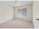 Bright, carpeted bedroom with a window view, providing a simple and peaceful retreat at 1303 Fontana Ct, Lady Lake, FL 32159