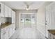 Eat-in kitchen area with white cabinets, granite countertops, tile floors, and a large bay window at 1303 Fontana Ct, Lady Lake, FL 32159