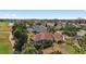 Aerial view of home with lanai, landscaping, and golf course views in a well-maintained community at 1312 Patrick Pl, The Villages, FL 32162