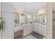 Bright bathroom features dual vanities, mirrors, and neutral tile flooring at 1312 Patrick Pl, The Villages, FL 32162