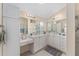 Bright bathroom featuring dual sinks, lots of counter space, and a glass shower at 1312 Patrick Pl, The Villages, FL 32162