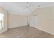 A spacious bedroom with wood floors, neutral walls, a ceiling fan, and a closet at 1312 Patrick Pl, The Villages, FL 32162