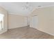 Empty bedroom featuring wood floors, a ceiling fan, closet with folding doors, and a side door at 1312 Patrick Pl, The Villages, FL 32162