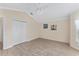 Bright, empty bedroom featuring wood floors, a ceiling fan, and a closet with folding doors at 1312 Patrick Pl, The Villages, FL 32162