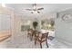 Bright dining area featuring a glass table, two chairs, marble floors and sliding glass door to the outdoor patio at 1312 Patrick Pl, The Villages, FL 32162