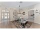 Open dining room featuring a glass table, decorative rug, and doorways to a foyer and kitchen at 1312 Patrick Pl, The Villages, FL 32162