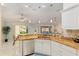 Bright kitchen featuring granite countertops, stainless steel appliances, and an open view to the backyard at 1312 Patrick Pl, The Villages, FL 32162