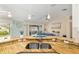 Open-concept kitchen features granite countertops, stainless steel sink, and pendant lighting overlooking living area at 1312 Patrick Pl, The Villages, FL 32162