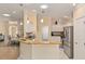 Open-concept kitchen featuring granite countertops, stainless steel appliances, and an adjacent dining area at 1312 Patrick Pl, The Villages, FL 32162