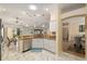 Open-concept kitchen featuring granite countertops, modern appliances, and bright lighting at 1312 Patrick Pl, The Villages, FL 32162