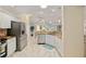Kitchen features stainless steel appliances, granite countertops, white cabinets, and tile floors at 1312 Patrick Pl, The Villages, FL 32162