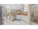 Spacious kitchen with granite countertops, stainless steel appliances, and lots of sunlight at 1312 Patrick Pl, The Villages, FL 32162