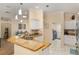 Kitchen featuring granite countertops, stainless steel appliances, pendant lighting, and access to the laundry room at 1312 Patrick Pl, The Villages, FL 32162