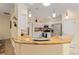 Well-lit kitchen featuring granite countertops, white cabinets, stainless steel appliances, and a kitchen pantry at 1312 Patrick Pl, The Villages, FL 32162