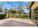 Enclosed lanai features a serene garden view, offering a tranquil outdoor living space at 1312 Patrick Pl, The Villages, FL 32162