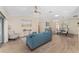 Inviting living room featuring wood floors, neutral walls and a blue sofa at 1312 Patrick Pl, The Villages, FL 32162