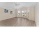 Spacious living room featuring wood floors, two windows, ceiling fan and vaulted ceiling at 1312 Patrick Pl, The Villages, FL 32162