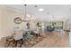 A well-lit living space with dining area, comfortable seating, and light wood floors at 1312 Patrick Pl, The Villages, FL 32162