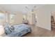 Comfortable bedroom featuring hardwood floors, neutral walls, and abundant natural light at 1312 Patrick Pl, The Villages, FL 32162