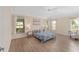 Bright main bedroom with hardwood floors, multiple windows, and neutral paint at 1312 Patrick Pl, The Villages, FL 32162