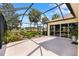 Enclosed patio area featuring an outdoor water feature and access to the main house through sliding glass doors at 1312 Patrick Pl, The Villages, FL 32162
