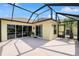 The screened-in patio features sliding glass doors and windows providing a seamless transition to outdoor living at 1312 Patrick Pl, The Villages, FL 32162