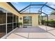 A covered lanai has multiple entries into the home and a decorative hanging wall ornament at 1312 Patrick Pl, The Villages, FL 32162