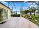 Enclosed patio featuring a tranquil waterfall and lush landscaping adding natural beauty to the outdoor space at 1312 Patrick Pl, The Villages, FL 32162