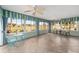 Bright sunroom features tiled floors and views of the backyard at 1312 Patrick Pl, The Villages, FL 32162