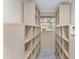 Spacious walk-in closet with custom built-in shelving for optimal storage and organization at 1312 Patrick Pl, The Villages, FL 32162