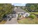 Aerial view of a well maintained home with a three car garage and mature landscaping at 1339 Florence Path, The Villages, FL 32162