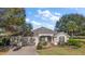 Inviting home featuring a three car garage, landscaped front yard, and manicured lawn at 1339 Florence Path, The Villages, FL 32162