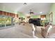 Bright living room featuring plush carpeting, a ceiling fan, and sliding glass doors to the outdoors at 1339 Florence Path, The Villages, FL 32162