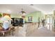 Inviting living room with a neutral color palette, plush carpeting, and access to the dining area and kitchen at 1339 Florence Path, The Villages, FL 32162