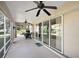 Relaxing screened patio with sliding glass doors, ceiling fans, and outdoor seating at 1339 Florence Path, The Villages, FL 32162