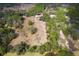 Expansive aerial view of the property showcasing the surrounding landscape and mature trees at 14100 Ne 46Th St, Silver Springs, FL 34488