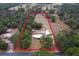 Aerial view of a property surrounded by trees, featuring a large parcel of land bordered by a red line at 14100 Ne 46Th St, Silver Springs, FL 34488