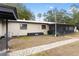 View of a backyard with a screened porch and brick paver walkway at 14100 Ne 46Th St, Silver Springs, FL 34488