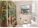 Comfortable bathroom featuring a unique forest-themed shower curtain and a window view at 14100 Ne 46Th St, Silver Springs, FL 34488