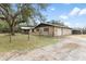 Exterior view of home with fenced yard and detached garage at 14100 Ne 46Th St, Silver Springs, FL 34488