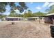 A ranch-style home with horse property including fencing and barn with shelters for horses at 14100 Ne 46Th St, Silver Springs, FL 34488