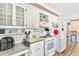 Functional kitchen with white cabinets, modern appliances, and a tiled backsplash at 14100 Ne 46Th St, Silver Springs, FL 34488