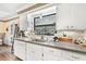 Updated kitchen with a stainless steel sink, white cabinets and stylish backsplash at 14100 Ne 46Th St, Silver Springs, FL 34488