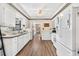 Spacious, light-filled kitchen with white cabinetry, modern appliances, and wood-look flooring at 14100 Ne 46Th St, Silver Springs, FL 34488